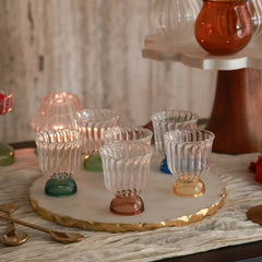 Mini Twirl Bowl - Set of 6 – empty fluted clear glass bowls with six coloured bases on a gold-edged marble platter