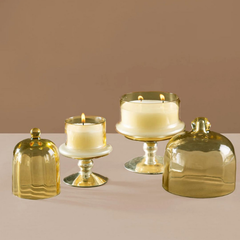 Sundance Aura Candle - Yellow, small and medium candles lit with yellow glass cloches set aside