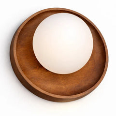 Elegant walnut wall-mounted light fixture featuring a circular wooden base with a frosted white globe shade, shown against a plain white background.