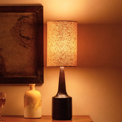 Decorative Petal Table Lamp with textured lampshade with wooden vase on a wooden surface and warm lighting.