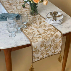 Rosabelle Chintz Ochre Table Runner on marble dining table with glassware and plates