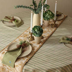 Rosabelle Chintz Ochre Table Runner on striped tablecloth with candles and green napkins
