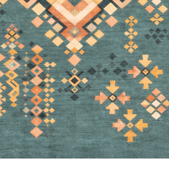 Geometric patterned rug with orange, yellow, and black on a teal background