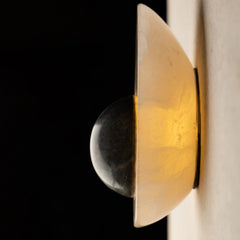 Side View of Alabaster wall sconce casting soft ambient glow