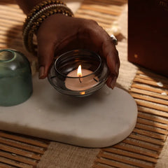 Muun Dome Tealight Holder, close-up of lit tealight in slate grey glass base beside teal dome