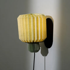 Modern linen wall sconce with origami-fold shade and metal bracket