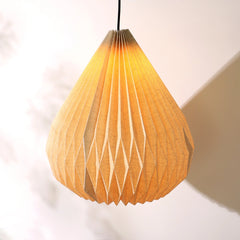 A beige linen dome pendant lamp hanging against a light background, displaying its pleated origami design.