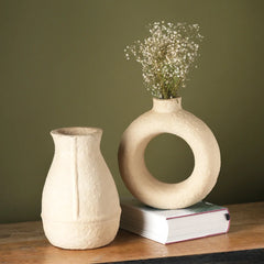 Decorative two ceramic paper mache vases on a wooden surface 