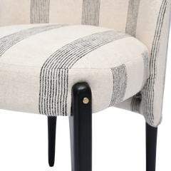 Close-up of a chair with striped patterned seat and black legs on a white background