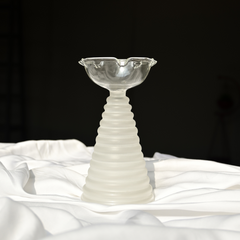 Tall glass diya in white at the bottom and clear glass on top