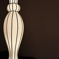 Close look of decorative lamp with striped design on a dark background