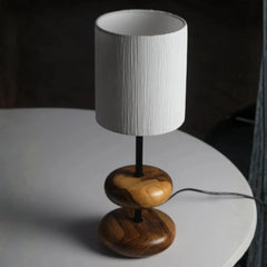 Earthy Wood Glow Bedside Table Lamp with wooden base and white shade on a gray surface