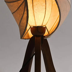 Close look of Kosh Table Lamp with a brown fabric shade and wooden base on a gray background