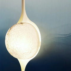 Decorative wall art showing pendant light with textured glass shade against a gradient background