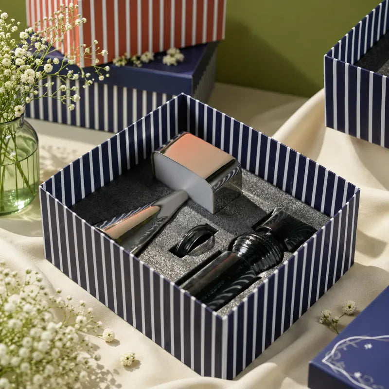 Portable Lamp & Glass Carafe gift set displayed in an open navy-and-white striped gift box.
