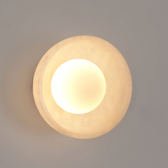 Close-up of mottled stone and brass hardware of Blot Wall Sconce Small wall light