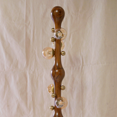 A vintage-style wooden floor lamp, featuring decorative clear glass globes and brass-colored metal accents.