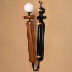 Two Dash & Dot wall sconces, one wooden and one black, on a beige background