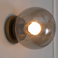 Aurora Noir wall sconce casting ambient glow on wall