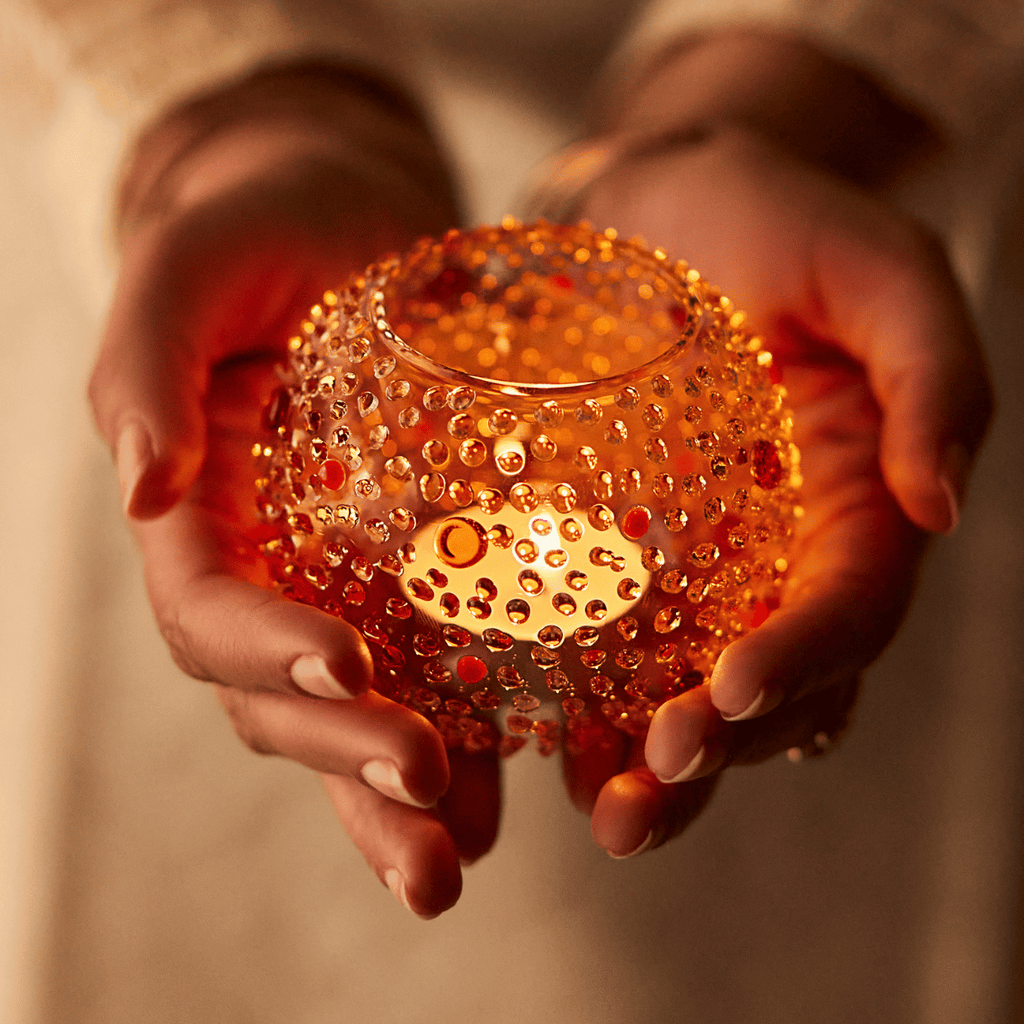 Borosilicate glass candle holder with dotted texture resembling Motichoor ladoo