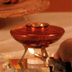 Muun Ghee Daani, tealight under metal base being lit with a torch lighter, amber glass pot above