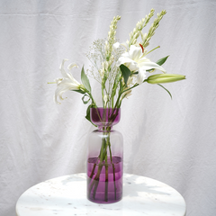 Decorative tinted glass vase with a retro-inspired shape, featuring a gradient of vibrant colors.