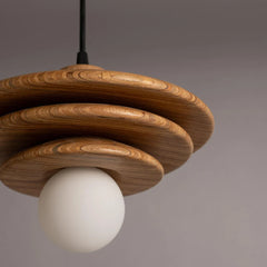 Closer look of wooden pendant light with a white bulb