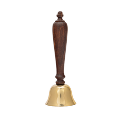 Brass bell with a wooden handle on a white background