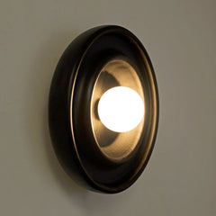 Side profile view of Discus Wall Light Black emphasizing its shallow depth and minimalist round form
