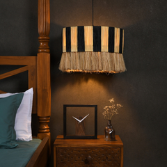 Hand Woven Cane Pendant Light in earthy texture hanging next to bedside