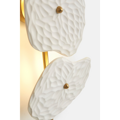 Close look of designer Organic Wall Lamp with a white ceramic body and gold-colored metal accents