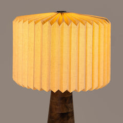Yellow warm light hikari table lamp with a unique design on a gray background