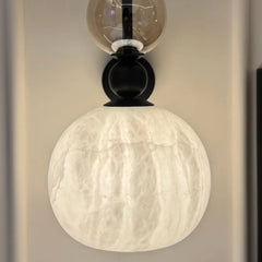 Close-up of wall sconce showing Alabaster panel glowing softly