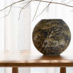 Decorative vase with tree design on a wooden table