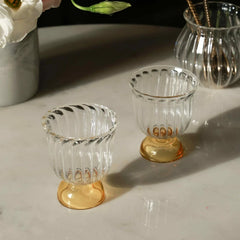 Mini Twirl Bowl - Set of 6 – fluted glass bowls with honey-yellow bases casting soft shadows on marble
