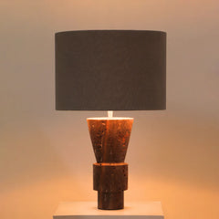 Ameo Table Lamp with a dark brown marble textured base and a black shade on a neutral background