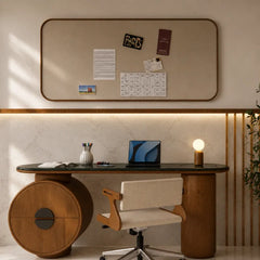A modern home office setup featuring a large beige corkboard with a rounded top mounted on a beige marble wall above a dark green desk with unique cylindrical wooden bases. A cream and wood swivel chair sits in front of the desk, alongside a laptop, lamp, and other desk accessories.