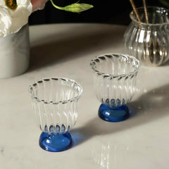 Mini Twirl Bowl - Set of 6 – swirled clear glass bowls with cobalt blue bases on a marble surface
