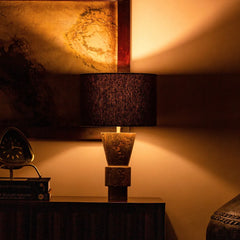 Decorative Ameo Table Lamp on a table with warm lighting