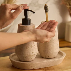 Otel Travertine Dispenser Set - In Use, Hands Pressing Black Pump