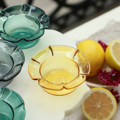PETAL - Mini Glass Server – top view of empty teal, clear black and yellow petal-edge bowls with fresh lemons
