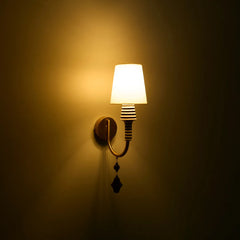 Stripe Wall Light with fabric shade, ceramic stem having graphic black-and-white striping and a warm brass arm casts a warm, ambient glow
