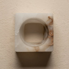 Tunnel Wall Sconce is a sculptural ambient wall lighting fixture made entirely from smooth alabaster.