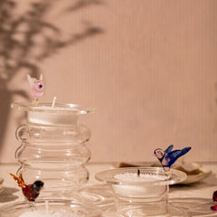 Unique Glass tea light holders with intricately detailed bird designs on the circular surface