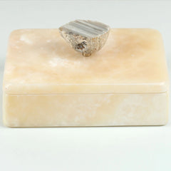 Rectangular marble box with a decorative stone on top against a white background