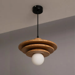 Wooden ceiling light with a white bulb hanging against a gray background
