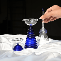Complete gift box set that includes Tall glass diya with blue ribbed pattern in bottom along with short diya and glass ringing bell 