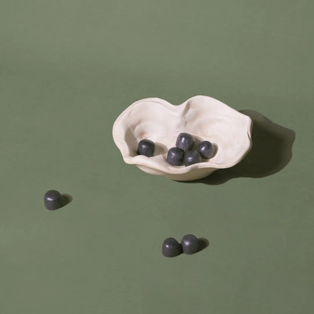 Kai Organic Bowl a white ceramic dish with blueberries on a green background