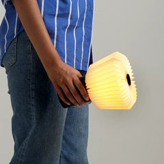 Person holding a glowing bouquet Table Lamp looks, portable and like a yellow lantern