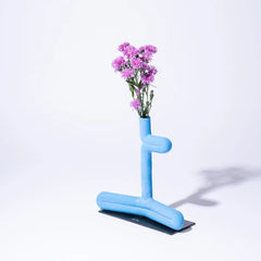 Designer Blue abstract vase with pink flowers on a white background